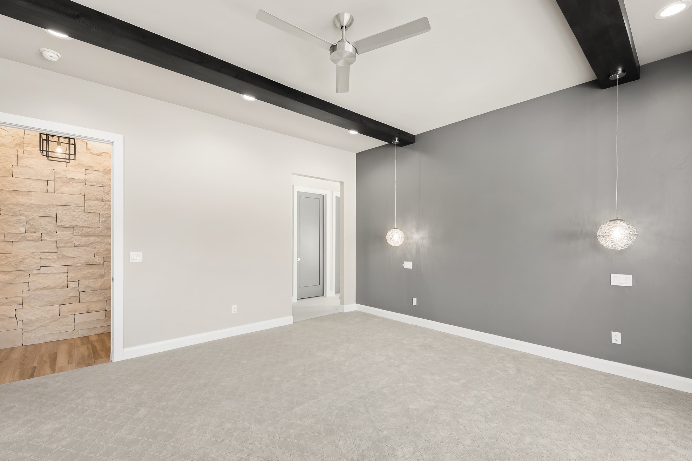 Bedroom with black ceiling beams and pendant lighting
