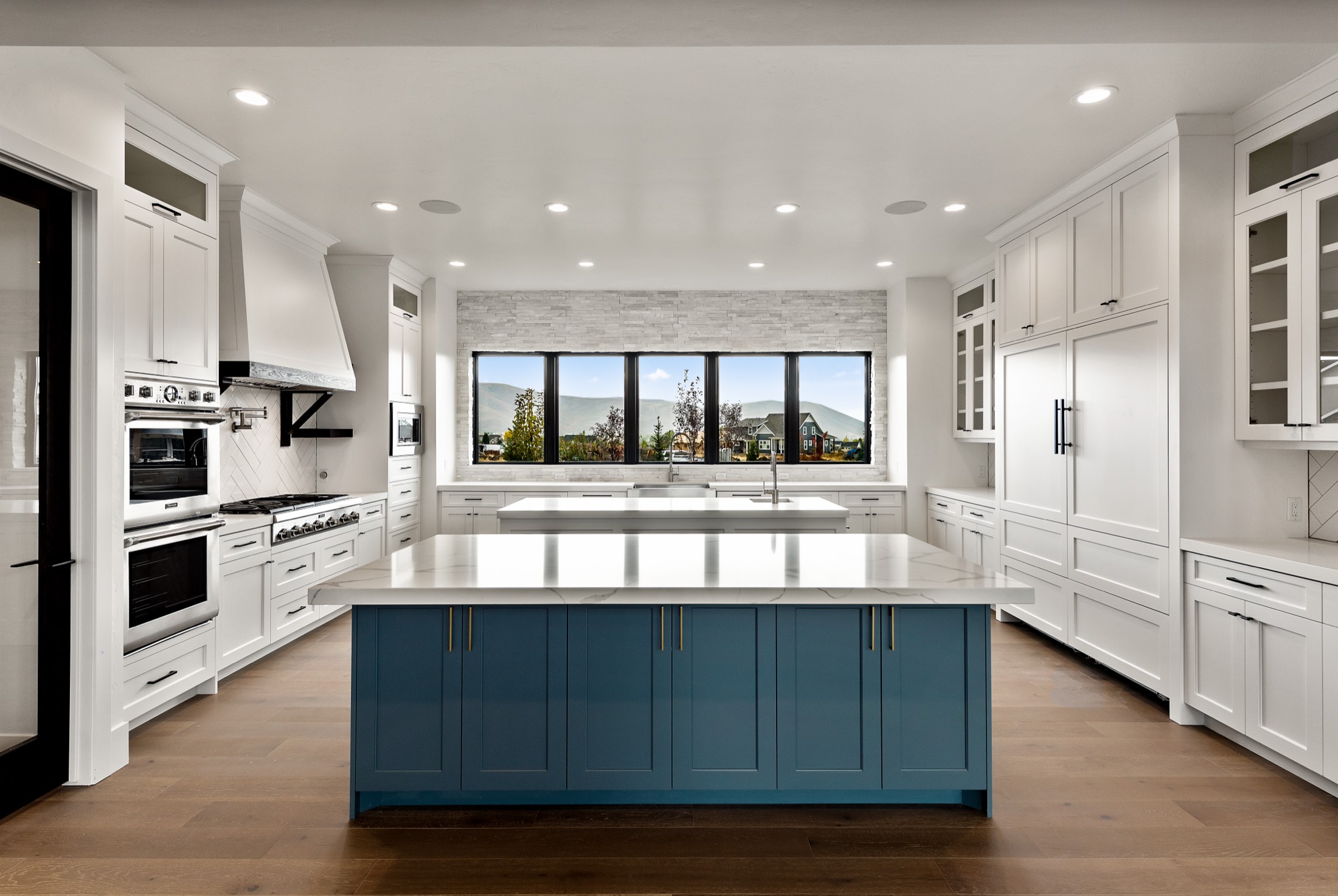 Kitchen with deep-blue island and valley views
