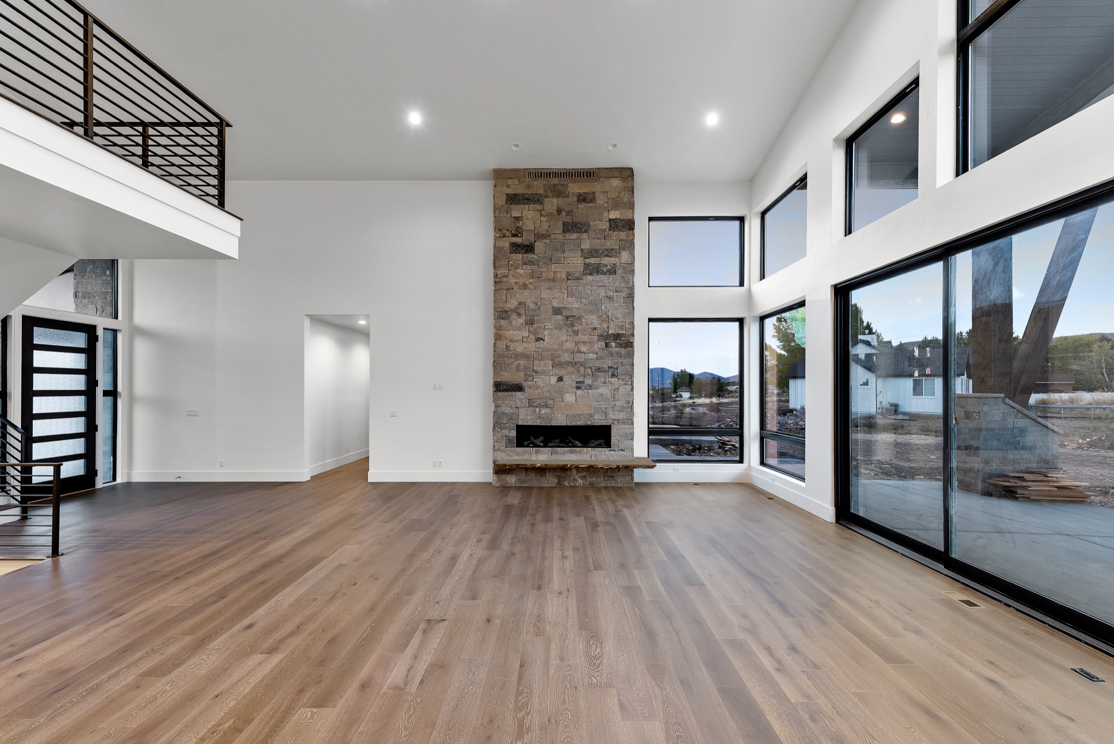 Great room with two-story stone fireplace