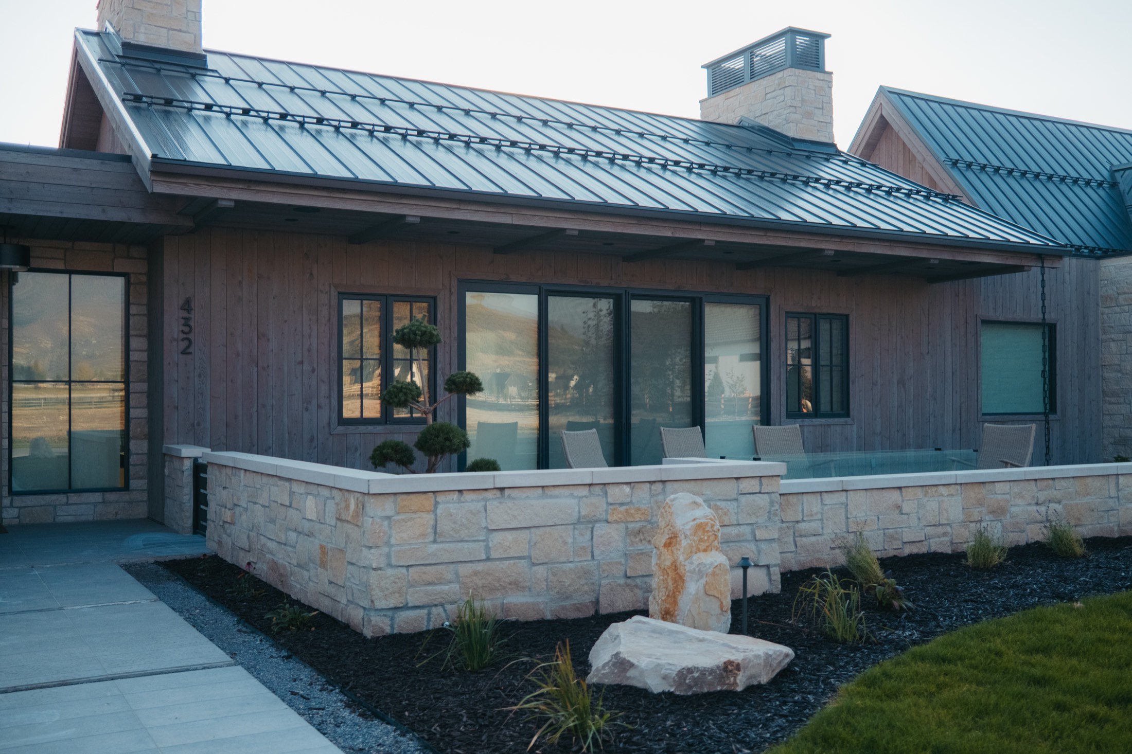 Front elevation in blackened timber and stone