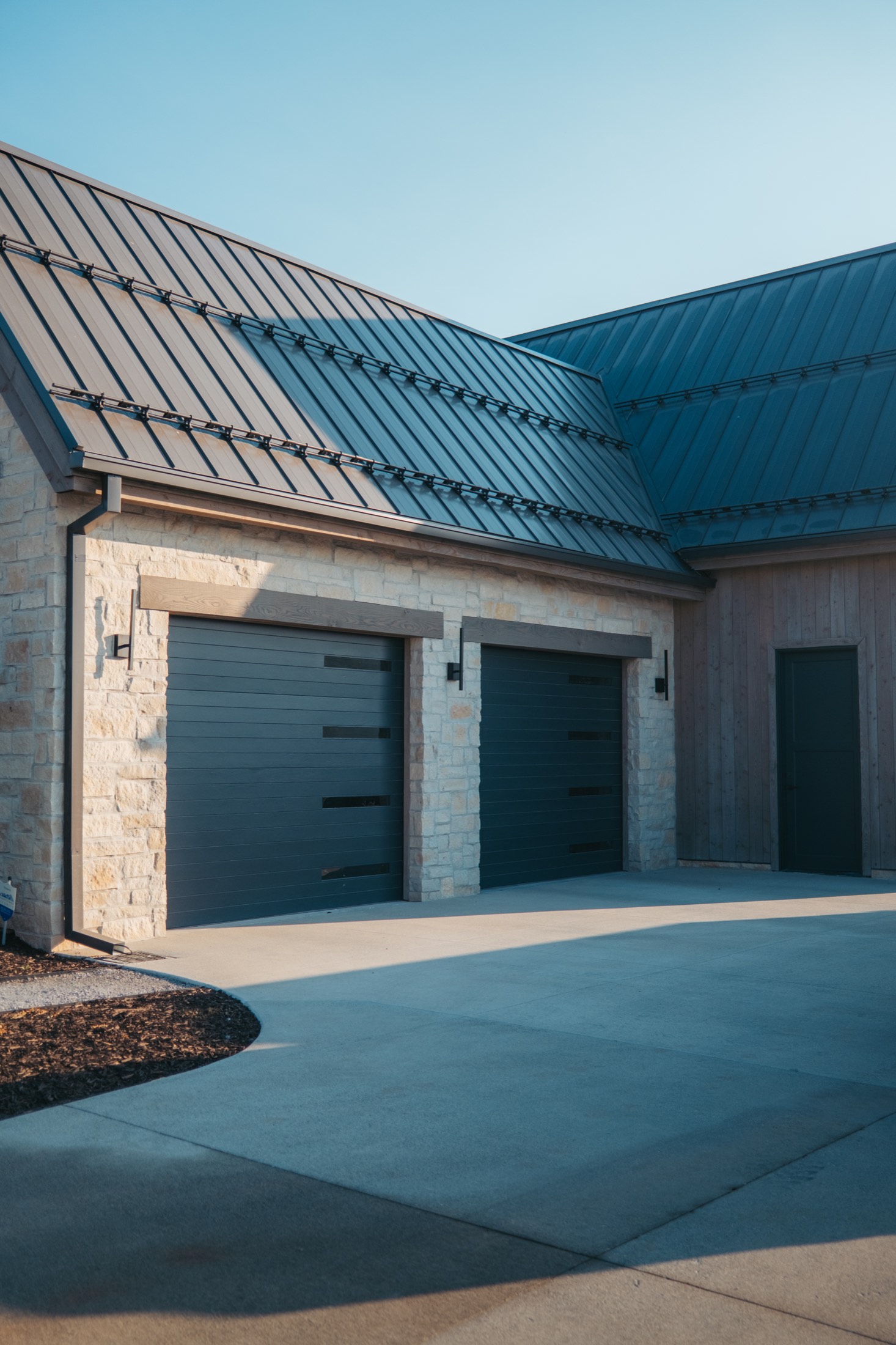 Stone and steel garage elevation
